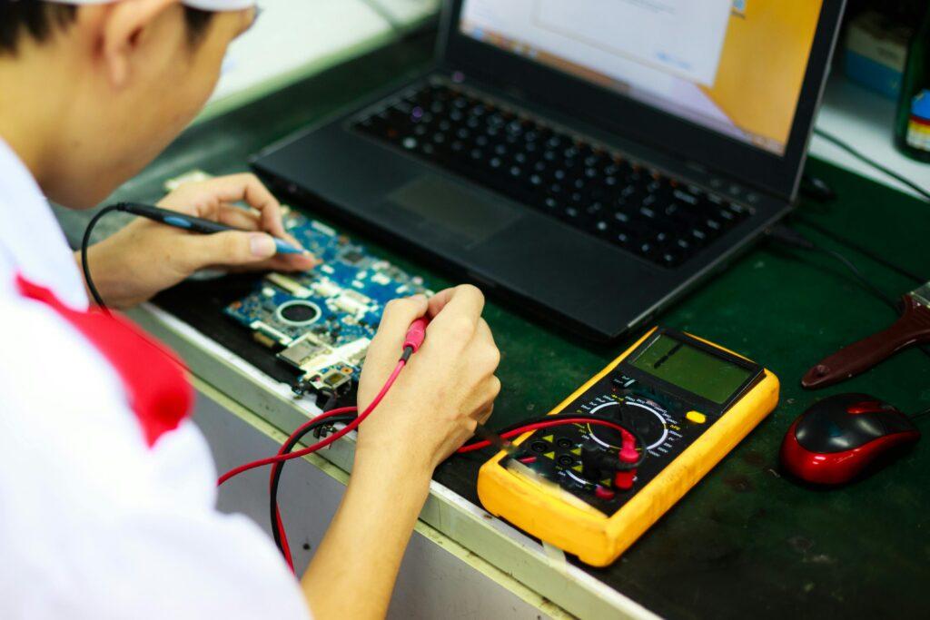 person measuring voltage on an electrical board